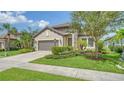 House exterior showcasing stone accents, landscaping and a two-car garage at 220 Capriana Ct, Nokomis, FL 34275