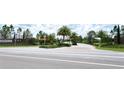 Community entrance with gated access and lush landscaping at 220 Capriana Ct, Nokomis, FL 34275