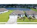 One-story home with gray siding, two car garage and paver driveway at 9018 Sunray Cv, Parrish, FL 34219