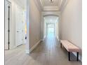 Bright entry hall with tile floors and bench at 341 Villoresi Blvd, Nokomis, FL 34275