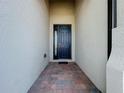 Home entryway with a dark blue door and brick-paved walkway at 341 Villoresi Blvd, Nokomis, FL 34275
