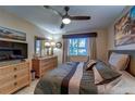 Bedroom with large bed, dresser and TV at 8911 Midnight Pass Rd # 110, Sarasota, FL 34242