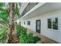 Condo building exterior with landscaping at 8911 Midnight Pass Rd # 110, Sarasota, FL 34242