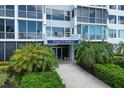 Elegant condo entrance with lush landscaping, a well-lit walkway, and a distinguished building sign at 555 S Gulfstream Ave # 804, Sarasota, FL 34236