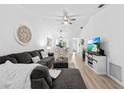 Open living space with L-shaped sofa and hardwood floors at 6050 28Th W St # 14B, Bradenton, FL 34207