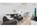 Bright living room featuring L-shaped sofa and dining area at 6050 28Th W St # 14B, Bradenton, FL 34207