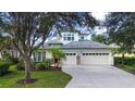 Two-story house with two-car garage and landscaping at 13814 Nighthawk Ter, Lakewood Ranch, FL 34202