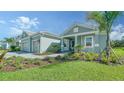 Two-car garage home with paver driveway and landscaping at 21281 Holmes Cir, Venice, FL 34293