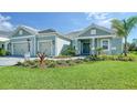 Two-car garage home with paver driveway and landscaping at 21281 Holmes Cir, Venice, FL 34293