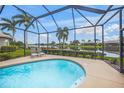 Relaxing screened-in pool area overlooking a tranquil lake at 2995 Bravura Lake Dr, Sarasota, FL 34240