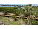 Scenic exterior view of a wooden walkway through a mangrove forest, with waterfront access at 1026 Bird Bay Way # 276, Venice, FL 34285