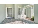 Front entry with gray door and paver walkway at 12420 Destin Loop, Venice, FL 34293