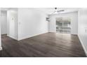 Spacious bedroom featuring dark grey vinyl flooring and sliding glass doors at 1522 Pleasant Rd # G23, Bradenton, FL 34207