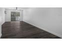Bright bedroom with dark grey vinyl flooring and access to a balcony at 1522 Pleasant Rd # G23, Bradenton, FL 34207