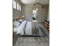 Bright bedroom with a ceiling fan, sliding glass door, and neutral decor for a calm and relaxing atmosphere at 7818 33Rd E St, Sarasota, FL 34243