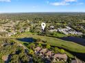 Aerial view of a condo community near a golf course and lake at 5070 Marsh Field Rd # 2, Sarasota, FL 34235