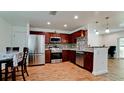 Modern kitchen featuring stainless steel appliances and granite countertops at 823 32Nd E Ave, Bradenton, FL 34208