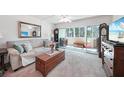 Living room with beige couch, wooden coffee table, and sliding glass doors to balcony at 21260 Brinson Ave # 210, Port Charlotte, FL 33952