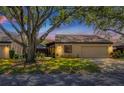 Inviting single-story home featuring a manicured lawn and mature trees providing ample shade at 3902 Glen Oaks Manor Dr, Sarasota, FL 34232