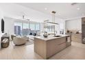 Open kitchen with island, modern appliances, and city views at 301 Quay Commons # 1209, Sarasota, FL 34236