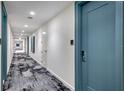 Building hallway with modern flooring and doors at 301 Quay Commons # 1209, Sarasota, FL 34236