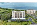 Aerial view of waterfront condo building with parking and landscaping at 2625 Terra Ceia Bay Blvd # 205, Palmetto, FL 34221