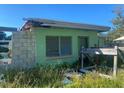 Damaged light green house with exposed framing at 108 Sago Ln, Nokomis, FL 34275