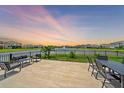 Backyard patio with seating area overlooking a lake at 5120 Vecchio Ct, Bradenton, FL 34211