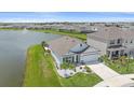 Aerial view of a house by the lake in a community at 5120 Vecchio Ct, Bradenton, FL 34211