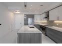 Modern kitchen with gray cabinets, white countertops, and stainless steel appliances at 111 S Pineapple Ave # 1021, Sarasota, FL 34236