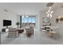 Bright living room with city views, modern chandelier, and ample natural light at 111 S Pineapple Ave # 1021, Sarasota, FL 34236