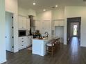 Spacious kitchen with a center island, pendant lighting, stainless appliances, and views into the dining area at 11709 Capstan Pl, Parrish, FL 34219