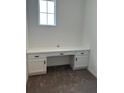 Bright office space features plush carpet and a built-in white desk with storage at 11722 Capstan Pl, Parrish, FL 34219