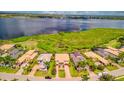 Stunning aerial shot showcases luxury homes with lush landscaping and scenic water views, offering a serene neighborhood at 5120 Tidewater Preserve Blvd, Bradenton, FL 34208