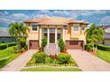 Beautiful two-story home with a well-manicured lawn, elegant landscaping, and a grand entrance at 5120 Tidewater Preserve Blvd, Bradenton, FL 34208