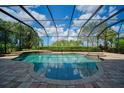 Inviting in-ground pool with a screened enclosure for enjoying the outdoors in comfort at 5120 Tidewater Preserve Blvd, Bradenton, FL 34208