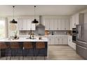 Modern kitchen with an island and stainless steel appliances at 8830 Windlass Cv, Parrish, FL 34219