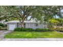 Gray house with a white garage door and manicured lawn at 401 28Th W St, Bradenton, FL 34205