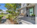 Inviting front porch with black railing and cozy seating area at 401 28Th W St, Bradenton, FL 34205