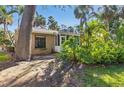 Backyard featuring lush greenery and screen enclosed porch at 5071 Village Gardens Dr # 5, Sarasota, FL 34234