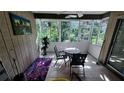 Enclosed sun room featuring tile floors, paneled walls and lots of natural light at 5071 Village Gardens Dr # 5, Sarasota, FL 34234