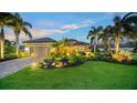 Well-maintained house with lush landscaping, and a brick paved driveway at dusk at 12663 Fontana Loop, Bradenton, FL 34211
