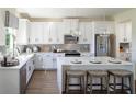 Modern kitchen with white cabinets and a large island at 8822 Windlass Cv, Parrish, FL 34219