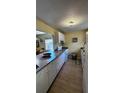 Bright kitchen with white cabinets, granite counters, and tile floor at 5071 Village Gardens Dr # 5, Sarasota, FL 34234