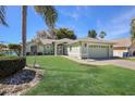 Light green house with a two-car garage at 5018 25Th E St, Bradenton, FL 34203