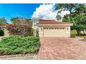 House exterior with a brick driveway and lush landscaping at 264 Woods Point Rd, Osprey, FL 34229