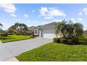 One-story house with white garage door and decorative driveway at 5207 Pine Shadow Ln, North Port, FL 34287