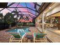 Relaxing pool and patio area with outdoor kitchen and seating at 14619 Leopard Creek Pl, Lakewood Ranch, FL 34202