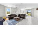 Open concept living room and kitchen with leather sectional at 7434 35Th E Ln, Sarasota, FL 34243