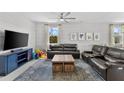 Spacious living room with leather sectional sofa and large TV at 7434 35Th E Ln, Sarasota, FL 34243